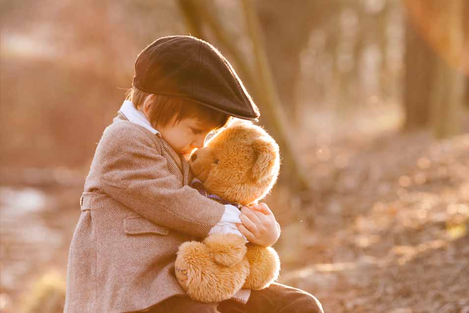 Picture of a boy holding a teddy bear