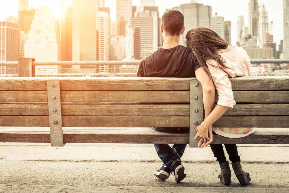 Two people sitting on a bench